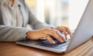 Laptop, email and worker typing for marketing, advertising or documents planning in corporate offic